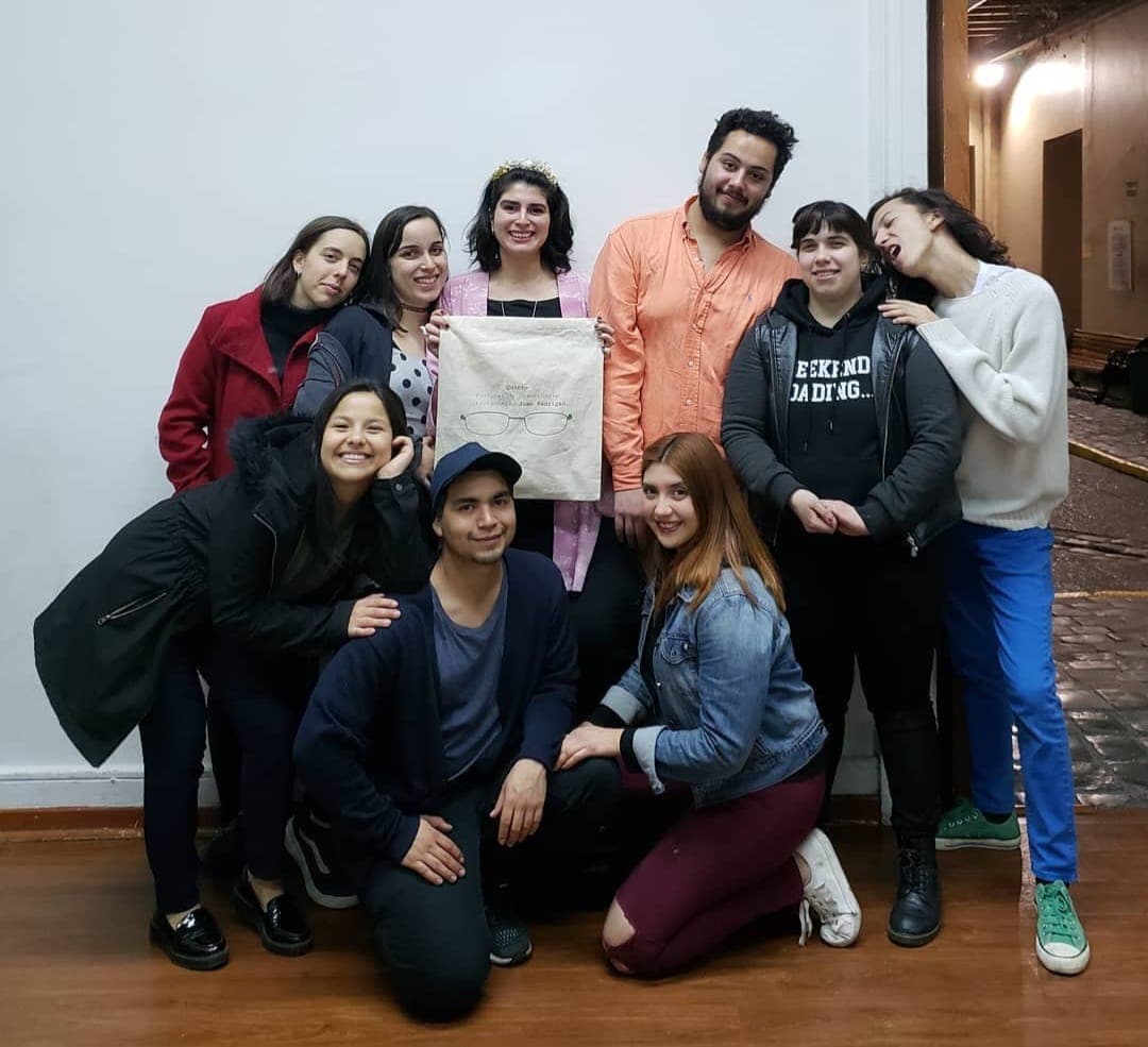 The fourth-edition team poses together, holding a tote bag with the festival logo.